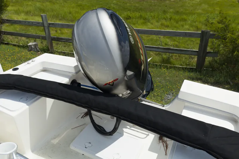 Slide: The Image of 2023 May-Craft 1900CC boat with Yamaha outboard motor, parked near a wooden fence. - 11
