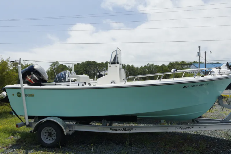 Slide: The Image of 2023 May-Craft 1900CC boat on trailer, featuring Yamaha outboard motor, parked outdoors. - 2