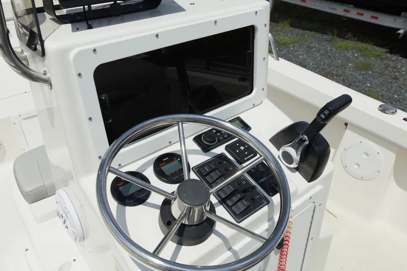 Slide: The Image of Steering console of 2023 May-Craft 1900CC boat with controls and gauges. - 13