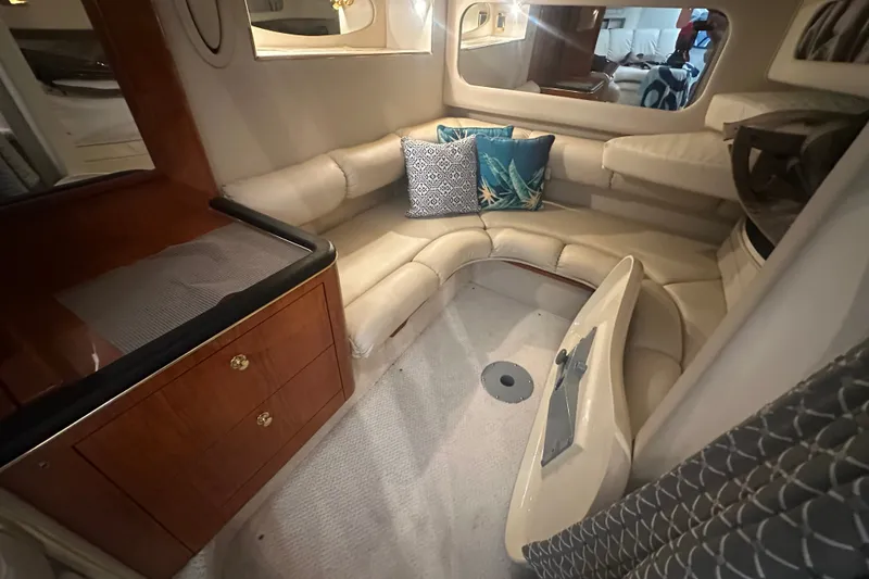 Slide: The Image of Interior of 1999 Sea Ray Sundancer 370 with beige seating and decorative pillows. - 24