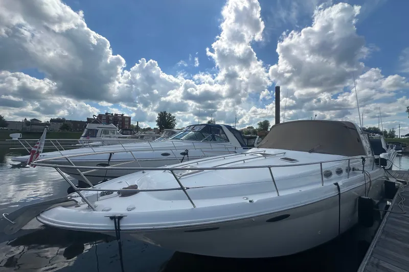 Slide: The Image of 1999 Sea Ray Sundancer 370 docked under a partly cloudy sky. - 2