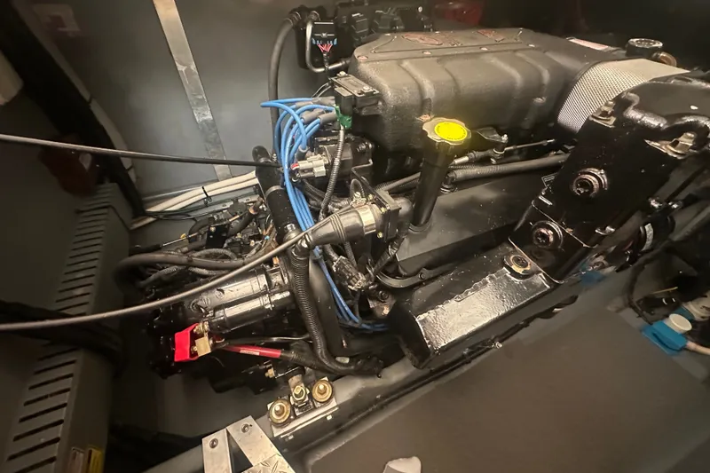 Slide: The Image of Engine compartment of a 1999 Sea Ray Sundancer 370, showcasing mechanical components and wiring. - 29
