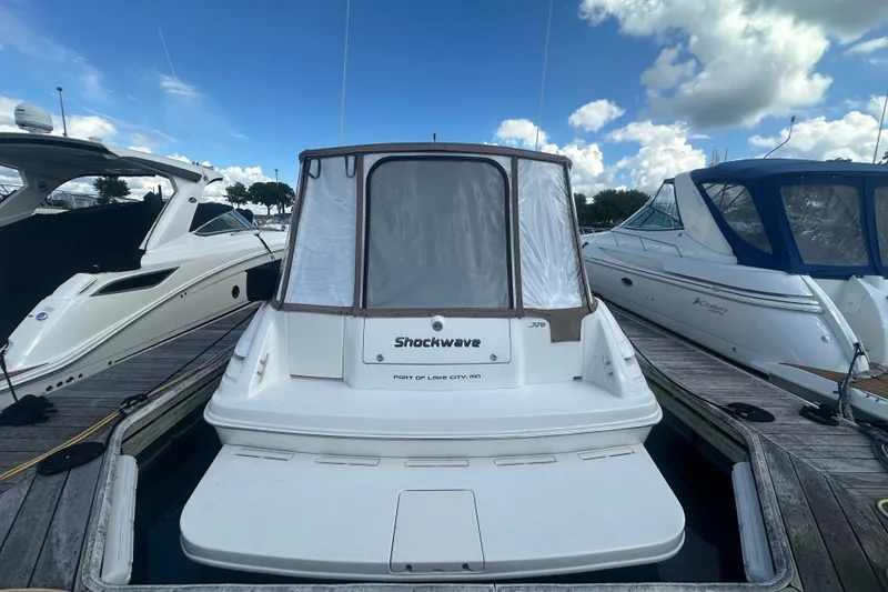Slide: The Image of 1999 Sea Ray Sundancer 370 docked at marina under blue sky. - 4