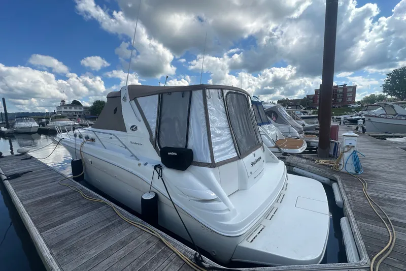 Slide: The Image of 1999 Sea Ray Sundancer 370 docked at marina under partly cloudy sky. - 1
