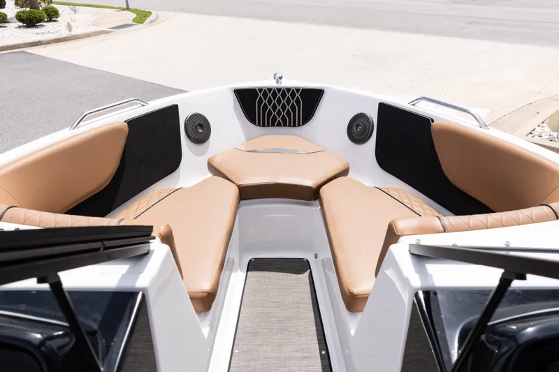 Slide: The Image of 2023 Glastron GX 210 boat interior with tan seating and modern design. - 8