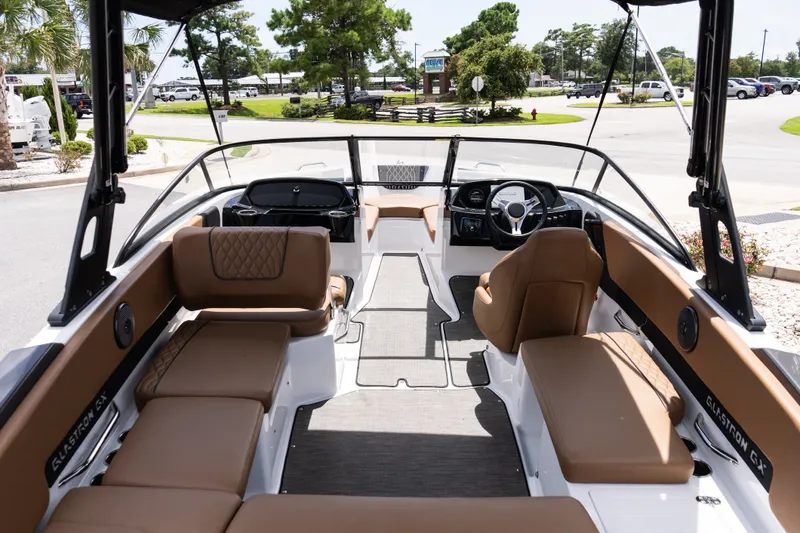 Slide: The Image of 2023 Glastron GX 210 boat interior with tan seating and modern dashboard. - 7