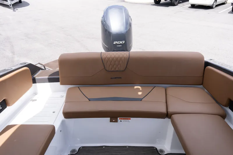 Slide: The Image of 2023 Glastron GX 210 boat interior with brown seating and Yamaha 200 engine. - 15