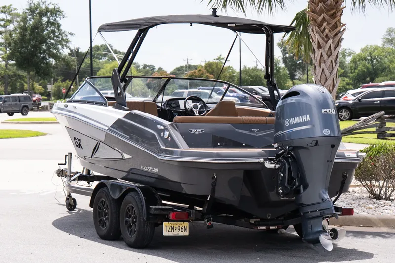 Slide: The Image of 2023 Glastron GX 210 boat with Yamaha 200 engine on a trailer. - 4
