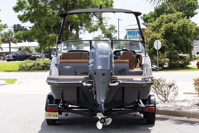 Slide: The Image of 2023 Glastron GX 210 boat with Yamaha 200 engine, parked on a trailer. - 5