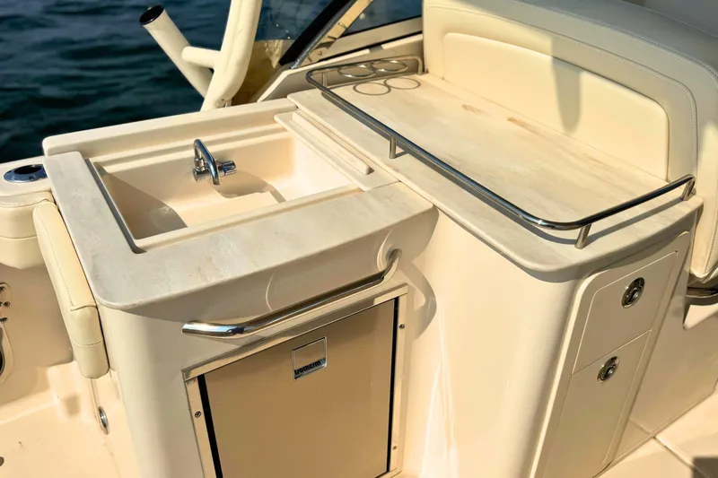Slide: The Image of 2023 Grady-White Freedom 285 boat interior with sink and storage area. - 21