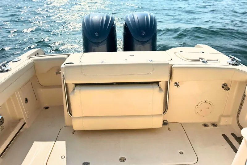 Slide: The Image of 2023 Grady-White Freedom 285 boat interior with dual engines on water. - 11