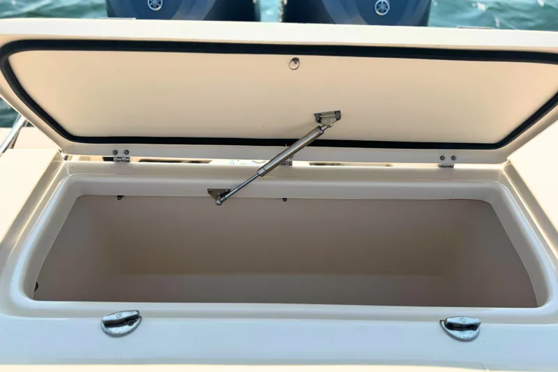 Slide: The Image of Open storage compartment on 2023 Grady-White Freedom 285 boat. - 13