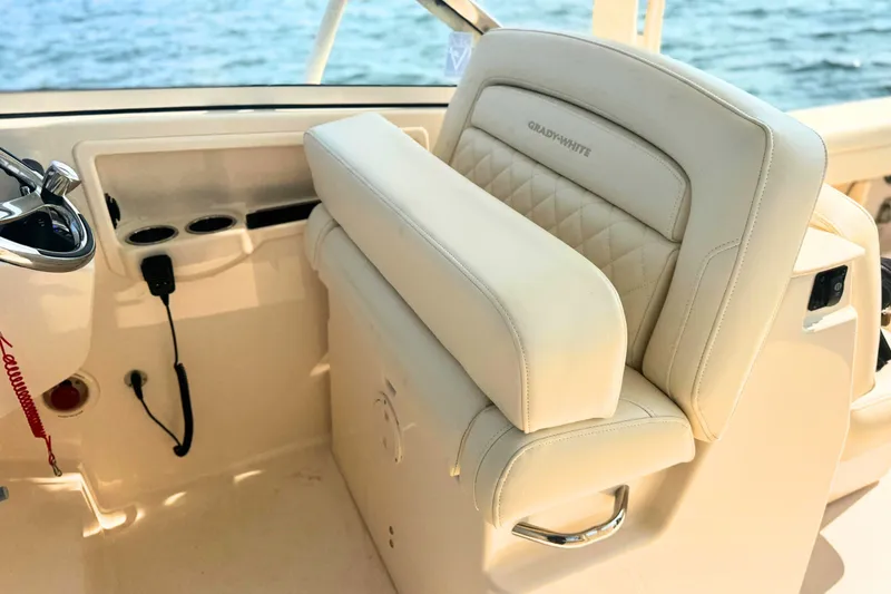 Slide: The Image of 2023 Grady-White Freedom 285 boat interior with luxurious seating and steering controls. - 37