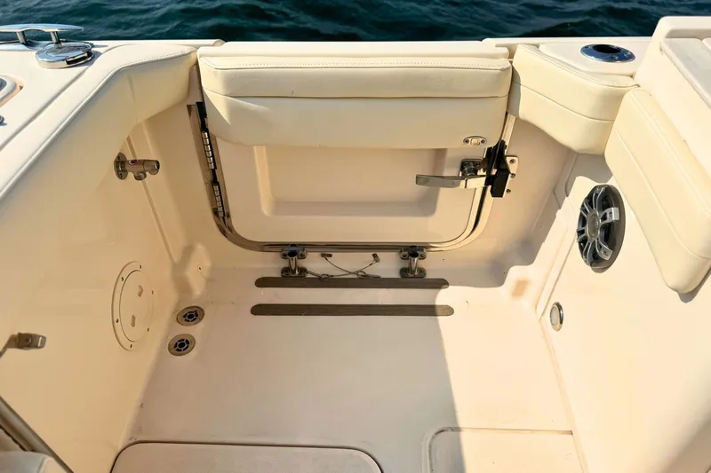 Slide: The Image of 2023 Grady-White Freedom 285 boat interior with seating and speaker, near water. - 18