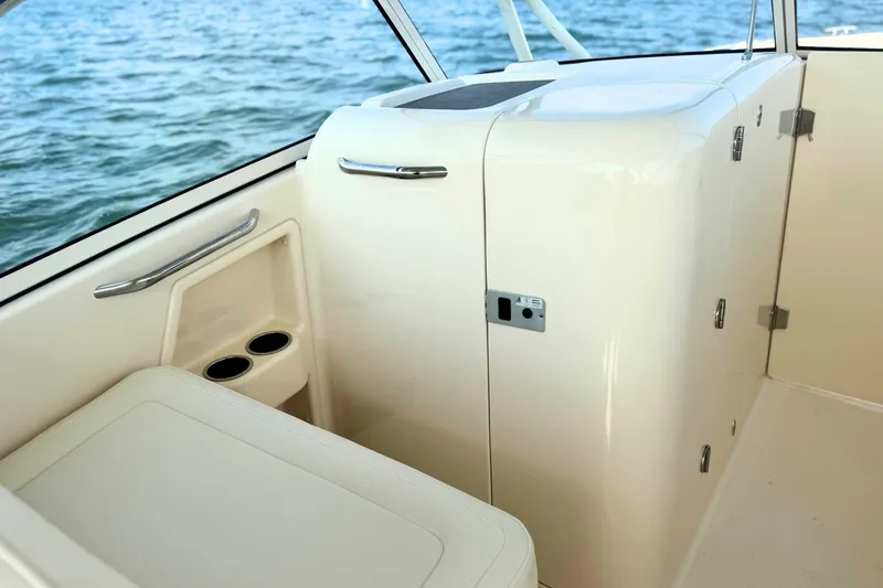 Slide: The Image of 2023 Grady-White Freedom 285 boat interior with seating and storage, overlooking the water. - 33