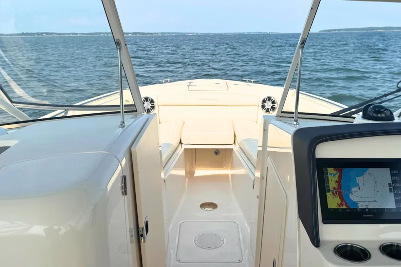 Slide: The Image of 2023 Grady-White Freedom 285 boat interior with navigation display, cruising on open water. - 42