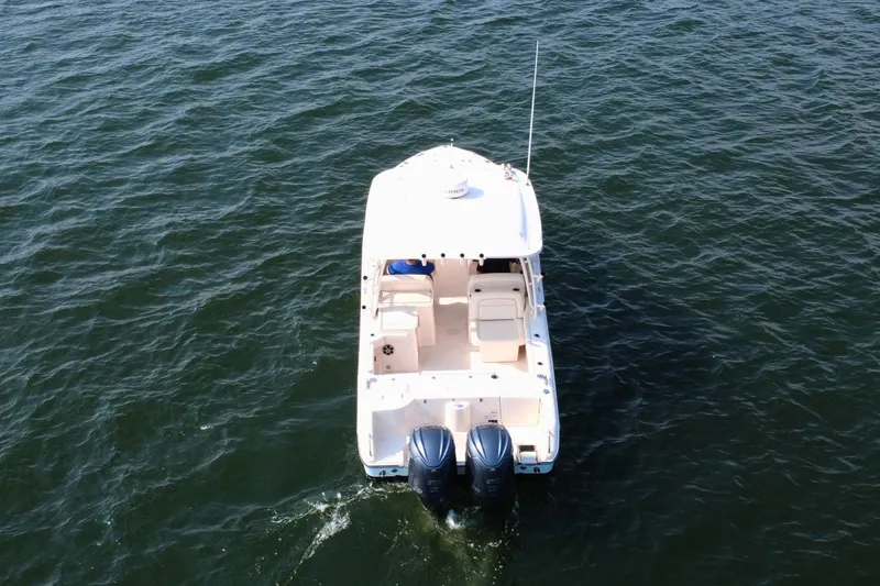 Slide: The Image of 2023 Grady-White Freedom 285 boat cruising on open water, aerial view. - 7