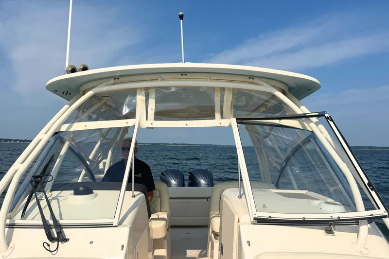 Slide: The Image of 2023 Grady-White Freedom 285 boat on open water, clear sky background. - 46