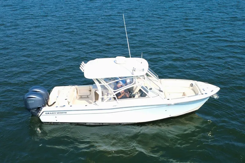 Slide: The Image of 2023 Grady-White Freedom 285 boat cruising on open water. - 3