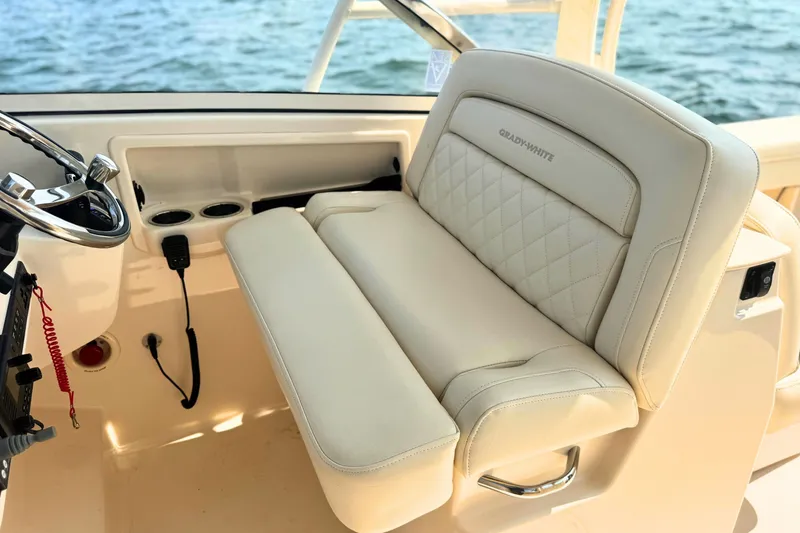 Slide: The Image of 2023 Grady-White Freedom 285 boat interior with luxurious seating and steering wheel. - 38