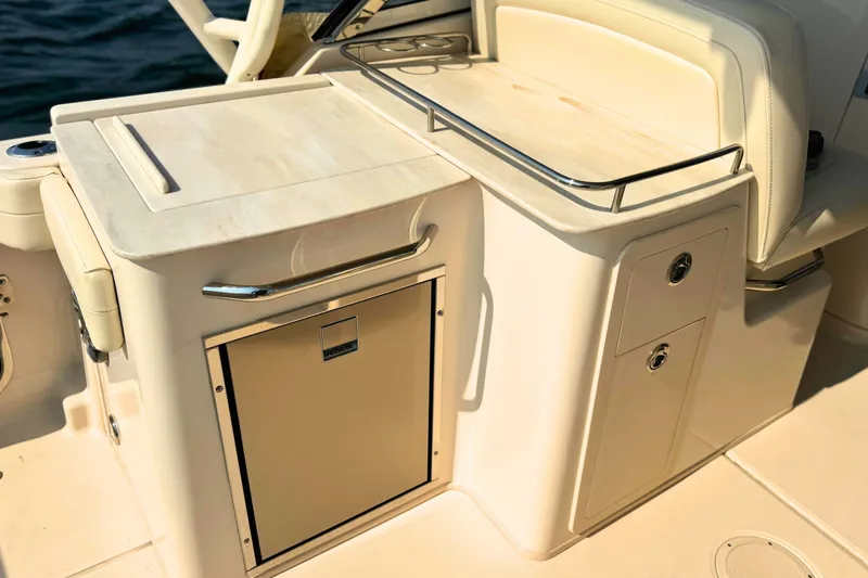 Slide: The Image of 2023 Grady-White Freedom 285 boat interior with storage and seating area. - 20