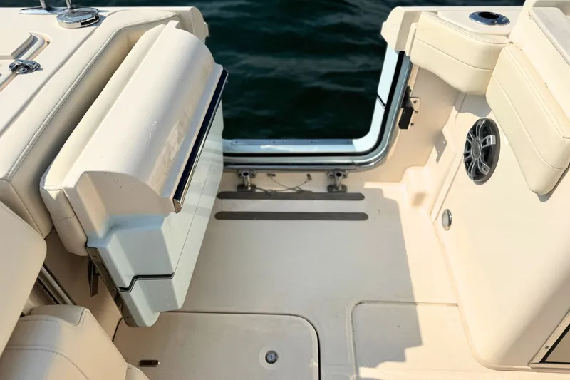 Slide: The Image of 2023 Grady-White Freedom 285 boat interior with seating and speaker, near water. - 19