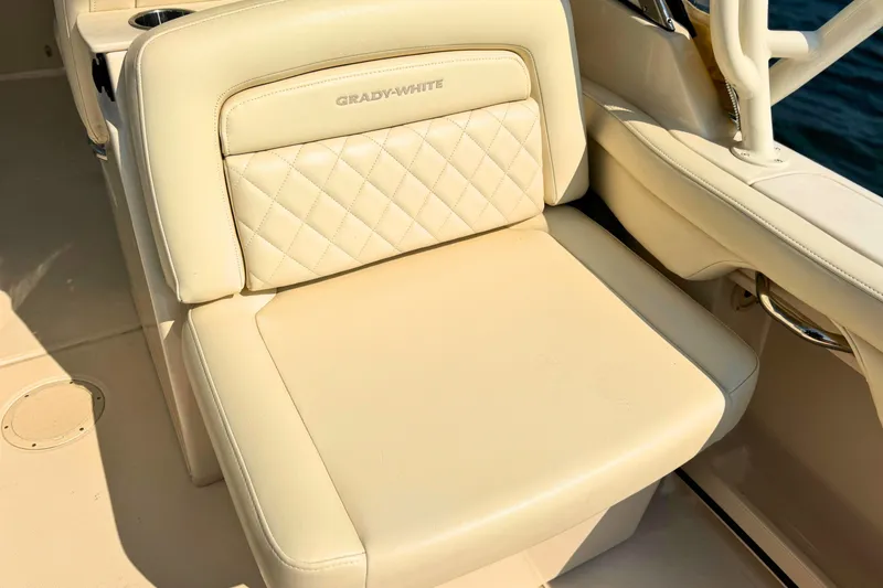 Slide: The Image of 2023 Grady-White Freedom 285 boat seat with beige upholstery and diamond stitching. - 29