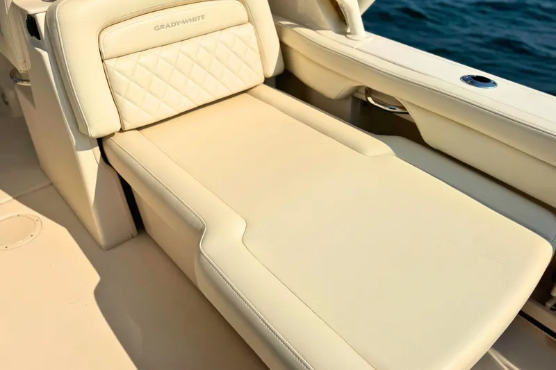 Slide: The Image of 2023 Grady-White Freedom 285 boat with luxurious beige seating by the water. - 30