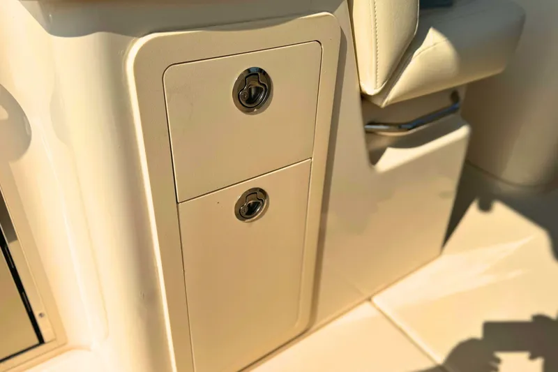 Slide: The Image of 2023 Grady-White Freedom 285 boat storage compartment with secure latches. - 26