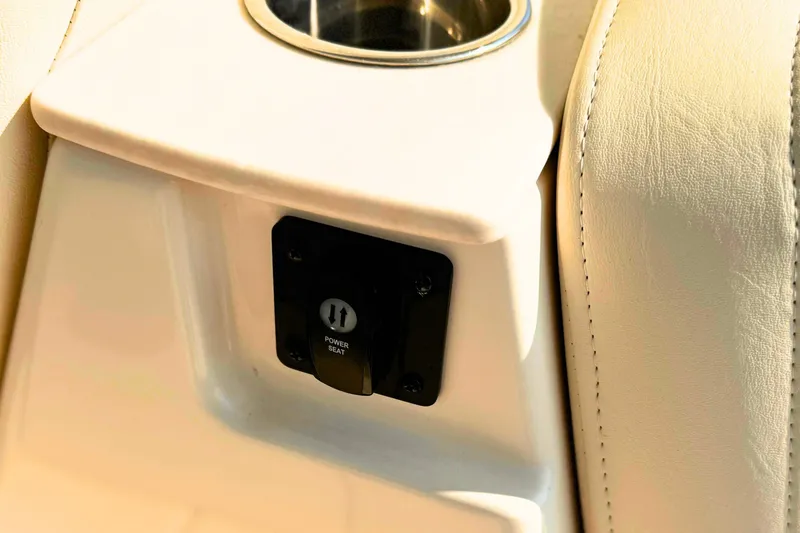 Slide: The Image of Power seat control on 2023 Grady-White Freedom 285 boat, next to cup holder. - 25
