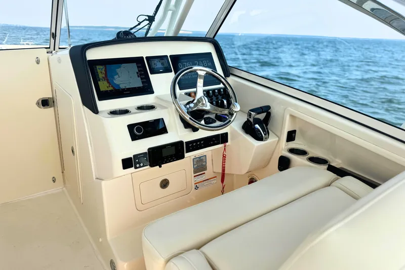 Slide: The Image of 2023 Grady-White Freedom 285 helm with modern navigation system and ocean view. - 36