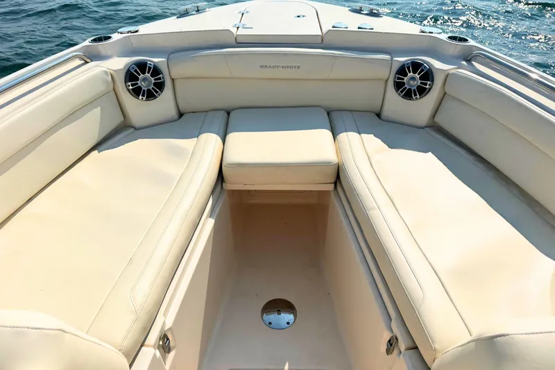 Slide: The Image of 2023 Grady-White Freedom 285 boat interior with beige seating and ocean backdrop. - 43