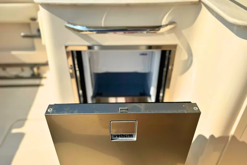Slide: The Image of Open refrigerator on 2023 Grady-White Freedom 285 boat, showcasing interior storage space. - 24