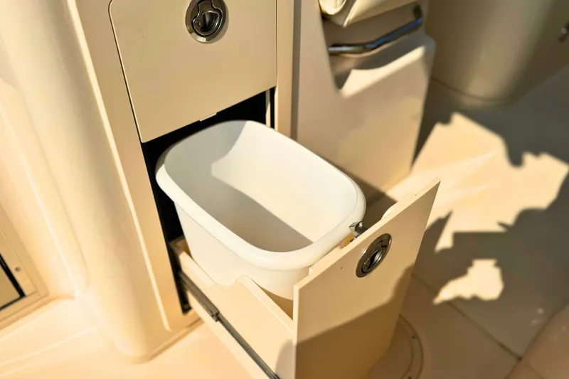 Slide: The Image of 2023 Grady-White Freedom 285 boat with built-in storage compartment and white container. - 28