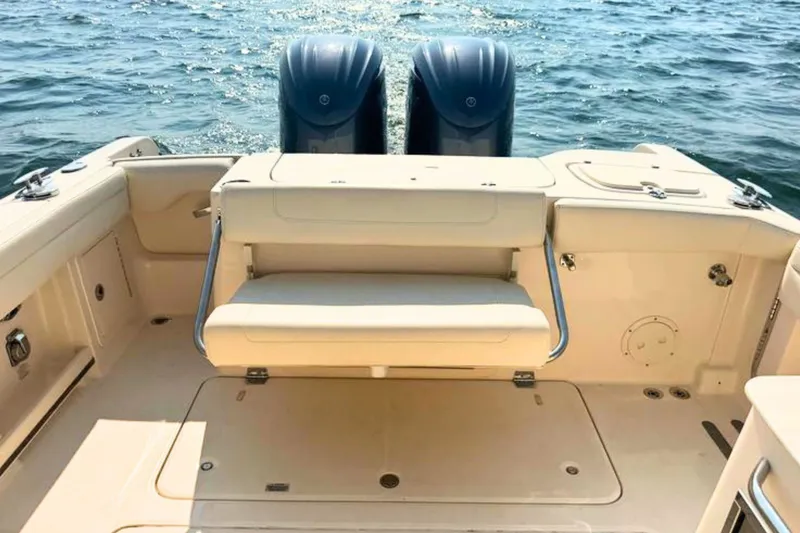 Slide: The Image of 2023 Grady-White Freedom 285 boat interior with dual engines on open water. - 12