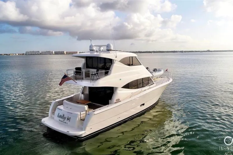 Slide: The Image of 2016 Maritimo M51 yacht cruising on calm waters under a partly cloudy sky. - 2