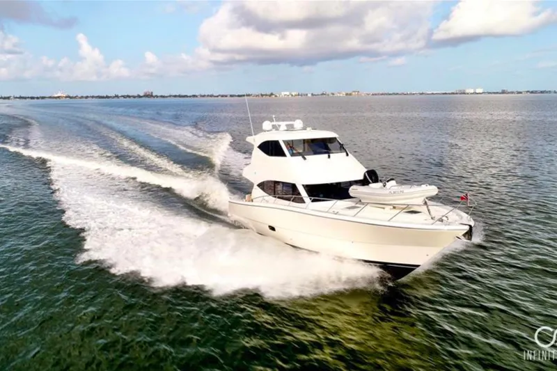 Slide: The Image of 2016 Maritimo M51 yacht cruising on open water under a clear blue sky. - 3