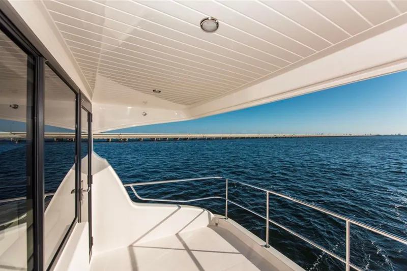Slide: The Image of 2016 Maritimo M51 yacht deck overlooking serene ocean and clear blue sky. - 13