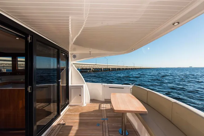Slide: The Image of Luxury 2016 Maritimo M51 yacht deck with ocean view and bridge in background. - 16