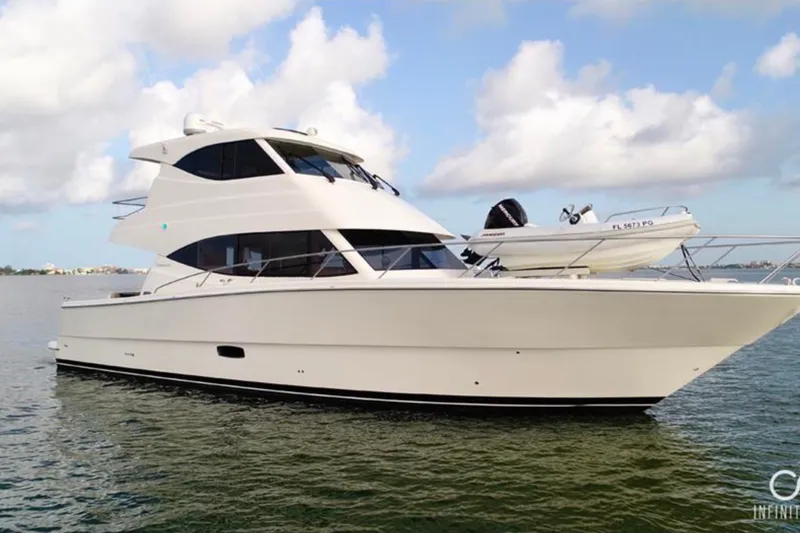 Slide: The Image of 2016 Maritimo M51 yacht on calm water under a partly cloudy sky. - 5