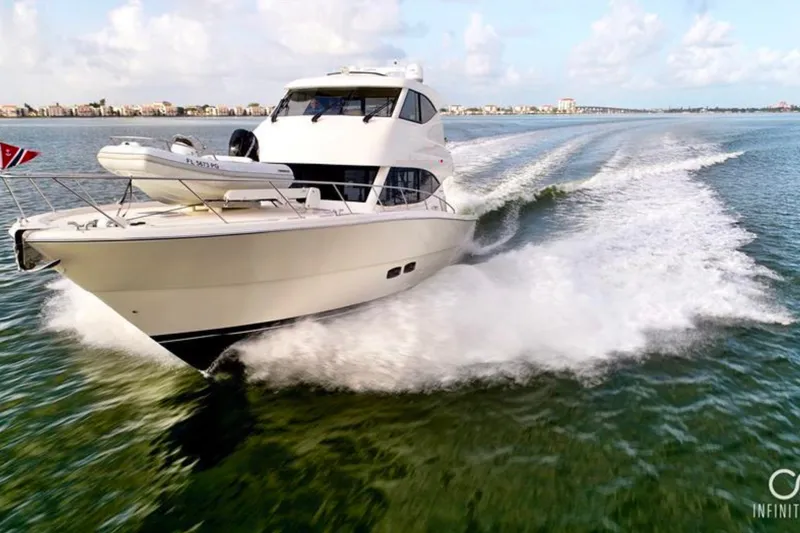 Slide: The Image of 2016 Maritimo M51 yacht cruising on open water, creating a dynamic wake. - 4
