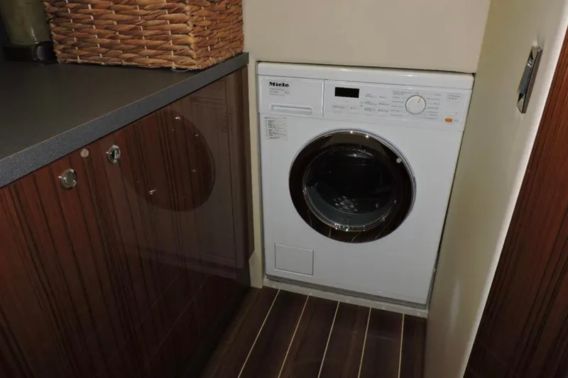 Slide: The Image of Laundry area with Miele washer in 2016 Maritimo M51 yacht interior. - 31