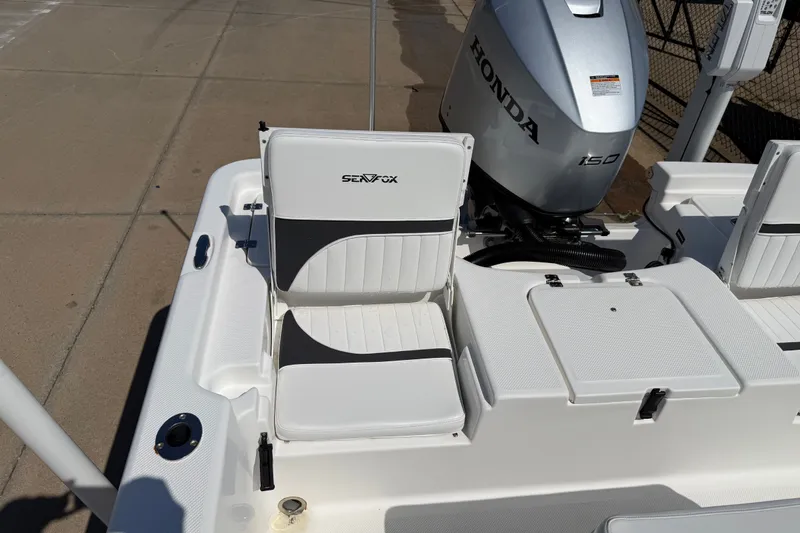 Slide: The Image of 2012 Sea Fox 200XT boat with Honda 150 engine, featuring white seating and deck. - 27