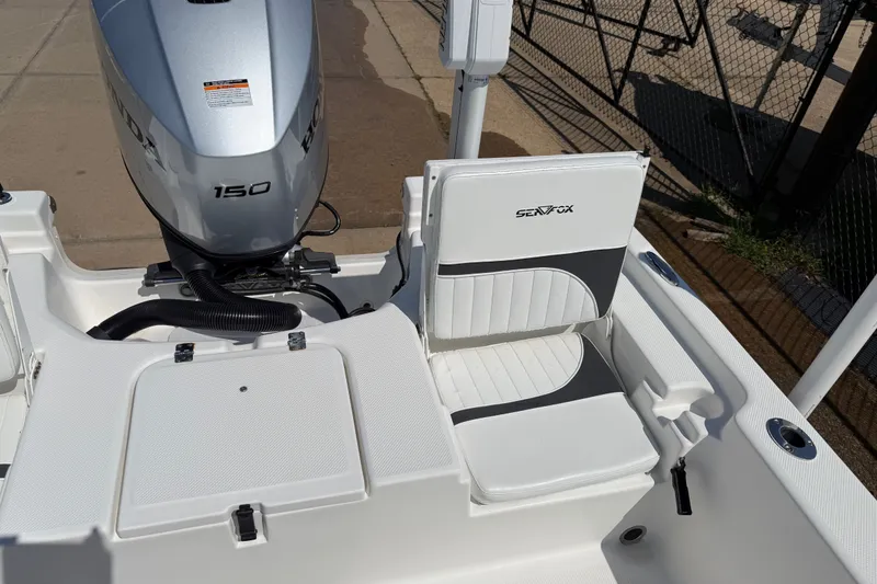 Slide: The Image of 2012 Sea Fox 200XT boat with Honda 150 engine and cushioned seating. - 28