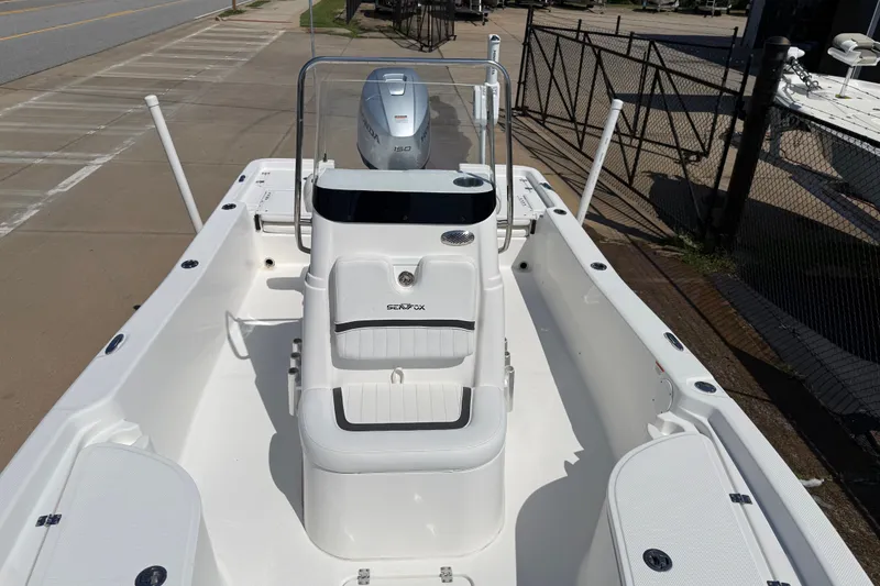 Slide: The Image of 2012 Sea Fox 200XT boat with Honda 150 engine, docked on a sunny day. - 21
