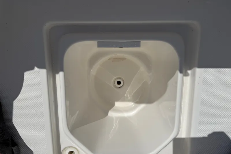 Slide: The Image of Interior compartment of a 2012 Sea Fox 200XT boat, featuring a drain hole. - 20