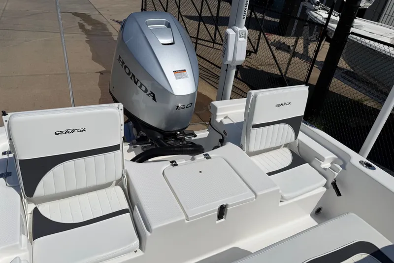 Slide: The Image of 2012 Sea Fox 200XT boat with Honda 150 engine, featuring white seating and deck. - 26