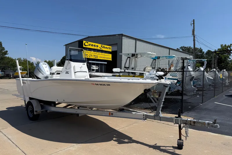 The Image of 2012 Sea Fox 200XT boat on trailer outside dealership, sunny day. - 5