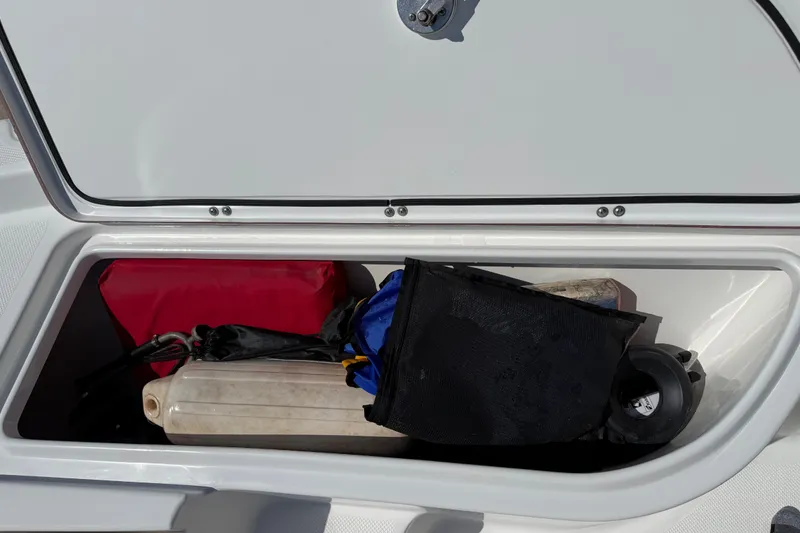 Slide: The Image of Storage compartment of a 2012 Sea Fox 200XT boat with various boating gear. - 19