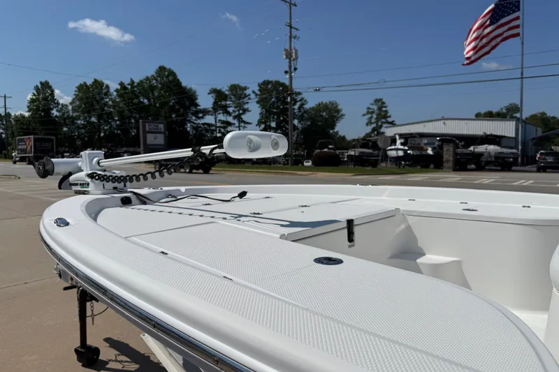Slide: The Image of 2012 Sea Fox 200XT boat with trolling motor, parked outdoors under a clear sky. - 32
